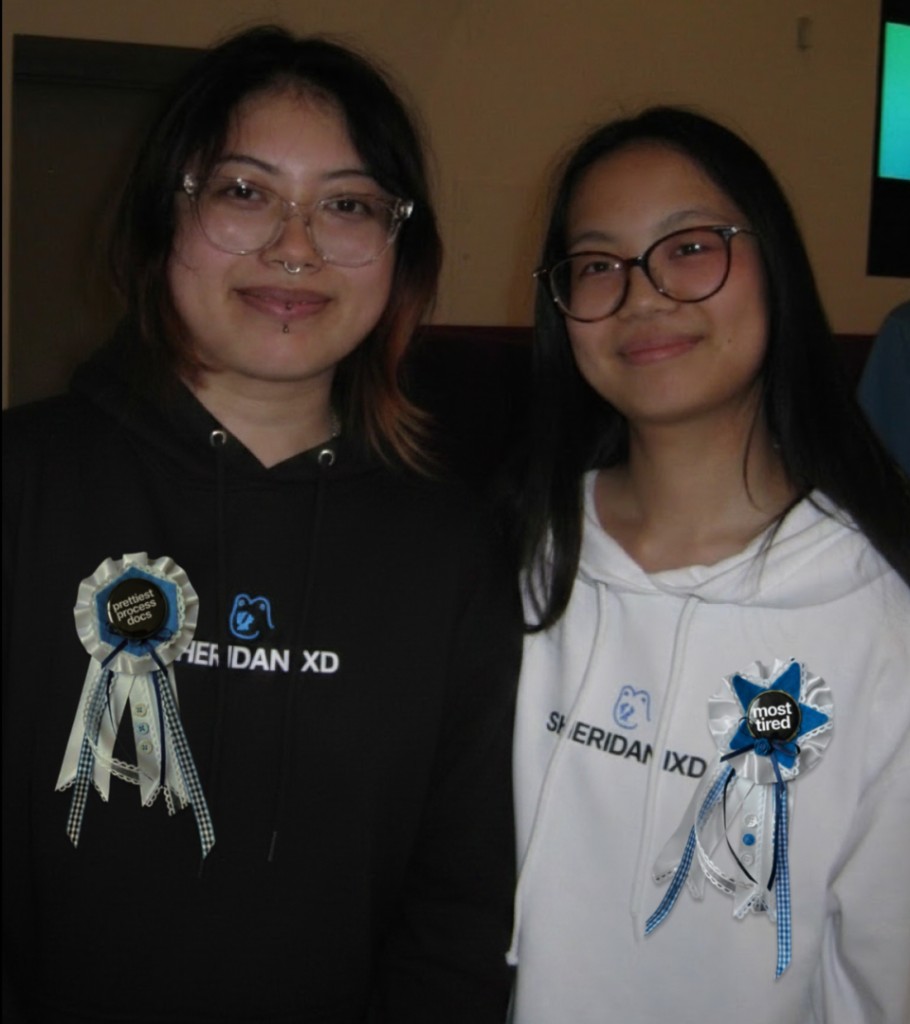 Students wearing Sheridan IXD hoodies with handmade award ribbons