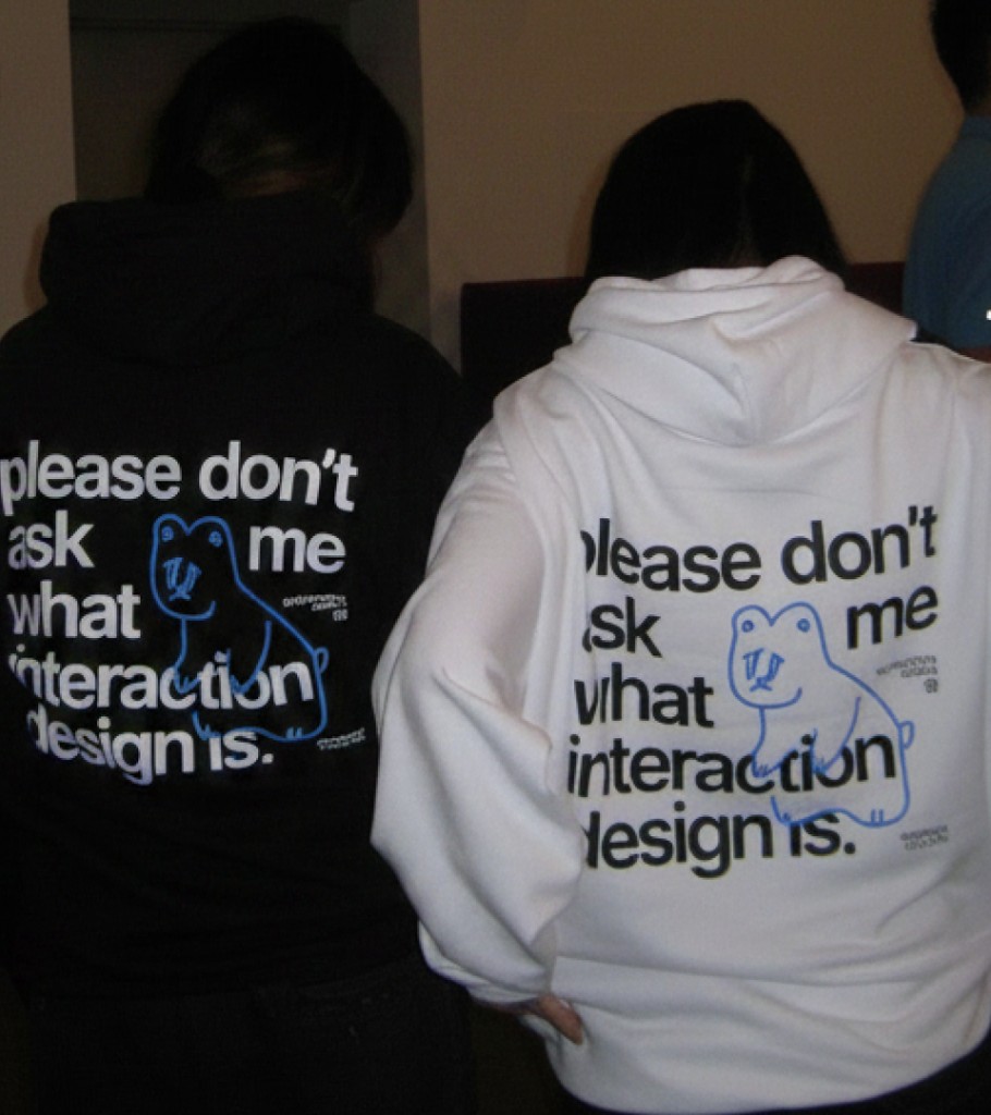 Black and white Sheridan IXD hoodies with please don't ask me what interaction design is printed on the back